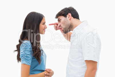 Angry man shouting at upset girlfriend