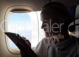 Woman sitting by illuminator in plane with touch pad