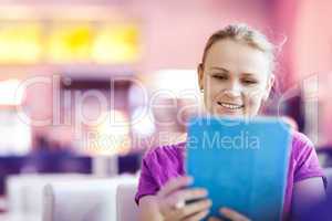 Woman using tablet PC in the restaurant indoors