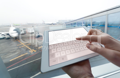Woman with tablet computer empty screen at airport