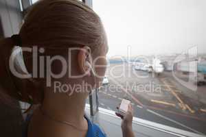 Woman in headphones looking at aiport area