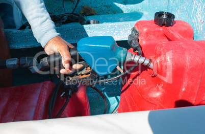 Man fueling tank of a motor boat before travel