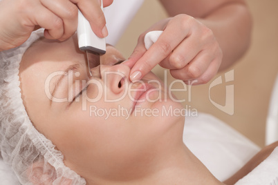 Face cleaning with ultrasonic equipment at beauty treatment salon