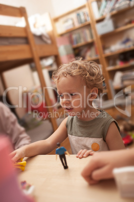 Little boy playing with toys in the room