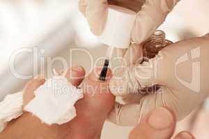Applying nail polish during pedicure at beauty spa