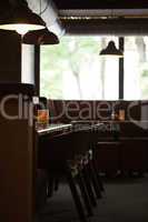 Empty cafe interior with wooden furniture and sofa