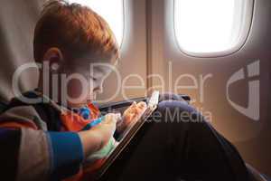 Child using tablet computer during flight