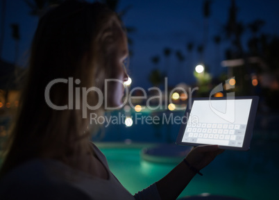 Woman tourist with pad on tropical resort in late evening
