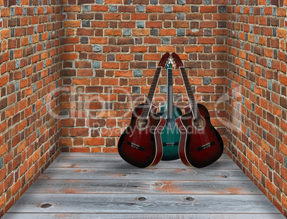 three guitars in the corner of the room