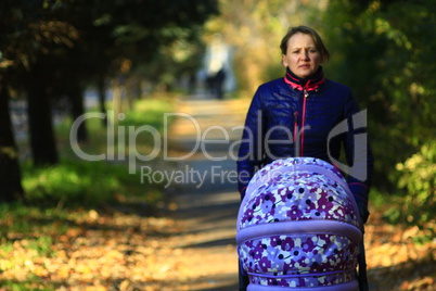 woman with perambulator in the park