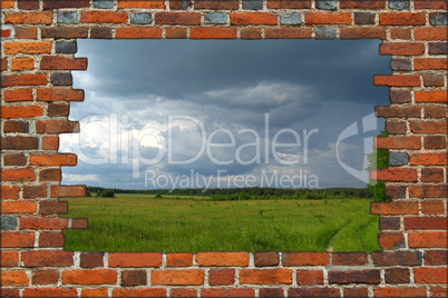 broken brick wall and view to field with thunder