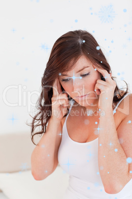 Composite image of attractive brunette woman having a headache w