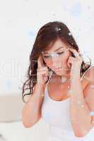 Composite image of attractive brunette woman having a headache w