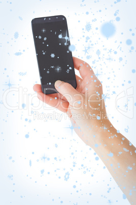 Composite image of female hand holding a smartphone