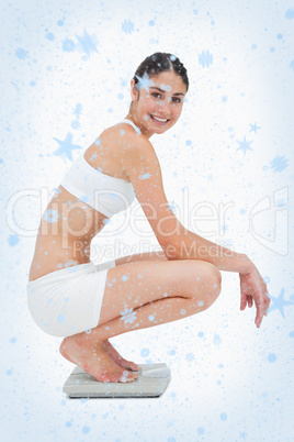 Composite image of slim young woman smiling while sitting on a s