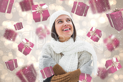 Composite image of brunette in warm clothing