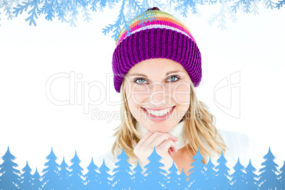 Composite image of merry woman with a colorful hat smiling at th