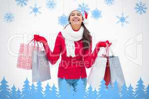 Composite image of beautiful festive woman holding shopping bags