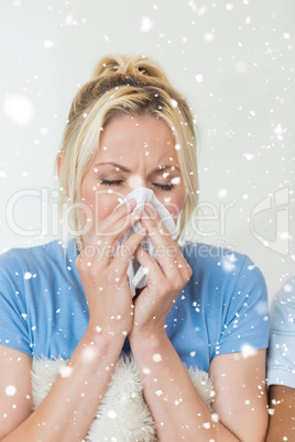 Composite image of closeup of a young woman suffering from cold