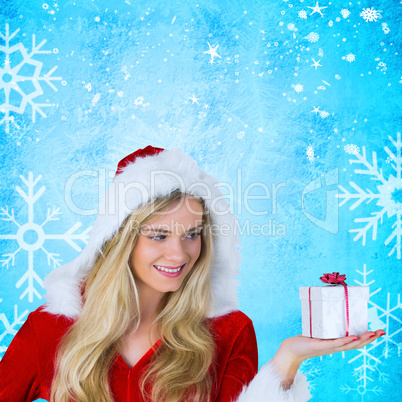 Composite image of pretty girl in santa outfit holding gift