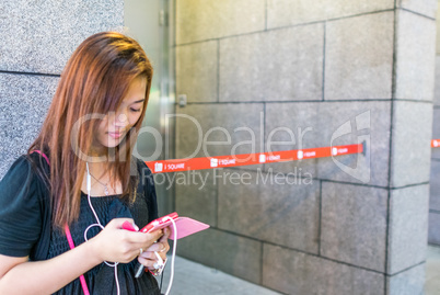 HONG KONG - APRIL 20, 2014: Girl writing sms on her smartphone.