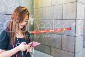 HONG KONG - APRIL 20, 2014: Girl writing sms on her smartphone.