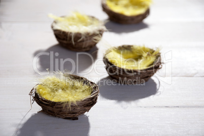 Close Up Of Easter Basket Nest With Yellow Feather