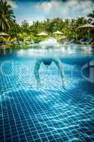Man floats underwater in pool