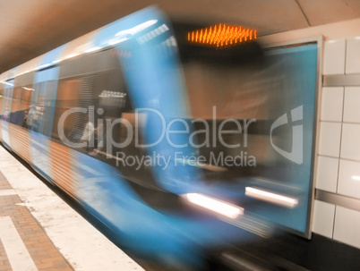 Fast moving train along subway platform