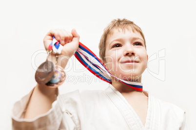 Smiling karate champion child boy gesturing for victory triumph