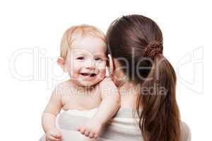 Loving mother holding little newborn smiling baby child