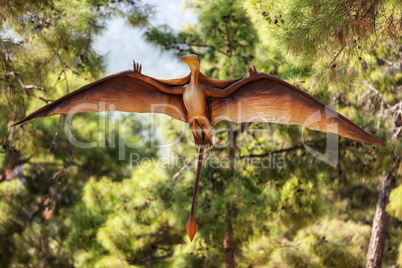 Pterodactyl dinosaur flying at forest