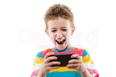 Smiling child boy playing games or surfing internet on smartphon