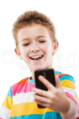 Smiling child boy holding mobile phone or smartphone taking self