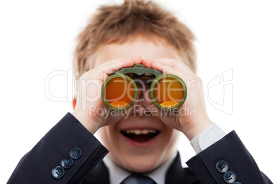 Child boy in business suit holding binoculars lens looking for d