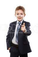 Smiling child boy in business suit index finger pointing directi