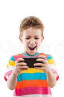 Smiling child boy playing games or surfing internet on smartphon