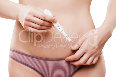 Beauty young woman hand holding pregnancy test showing two strip