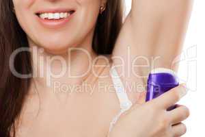 Beauty smiling young woman applying stick deodorant on armpit sk