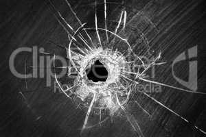 Bullet shot cracked hole on broken window glass