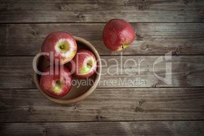 apples in a wooden saucer