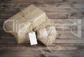 Heart and box wrapped in brown kraft paper with a price tag,  on