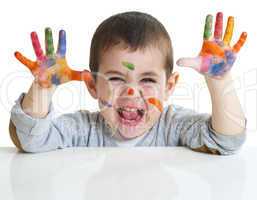 little boy with paints on hands