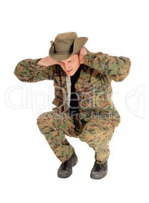 Soldier crouching on floor.