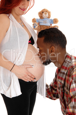 Man kissing wives belly.