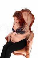 Pregnant woman in armchair.