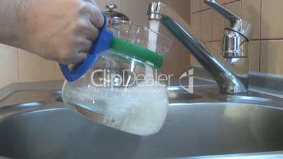 Filling glass kettle of water