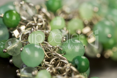 Green beads on an item of silver jewellery