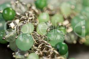 Green beads on an item of silver jewellery