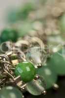 Green beads on an item of silver jewellery